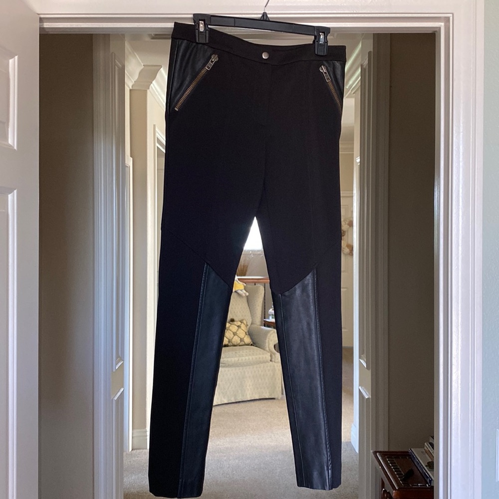 Rache Zoe black material pants with genuine soft black leather. No wear/tear.